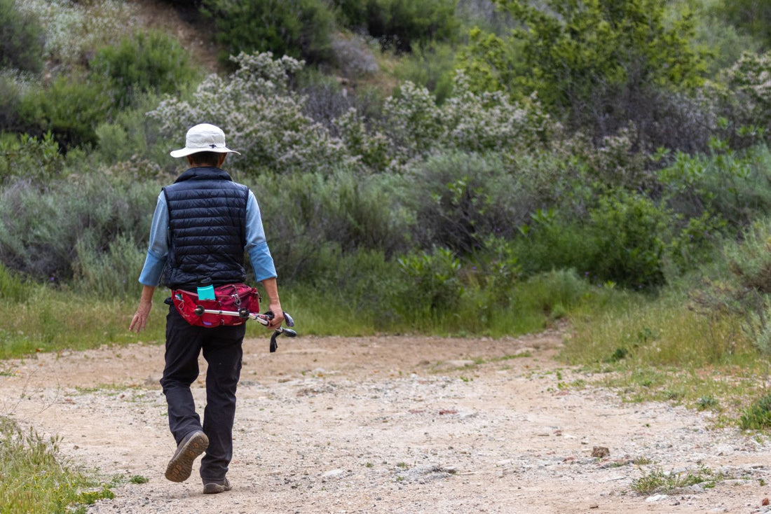 Hiker in hiking pants walking a dry trail